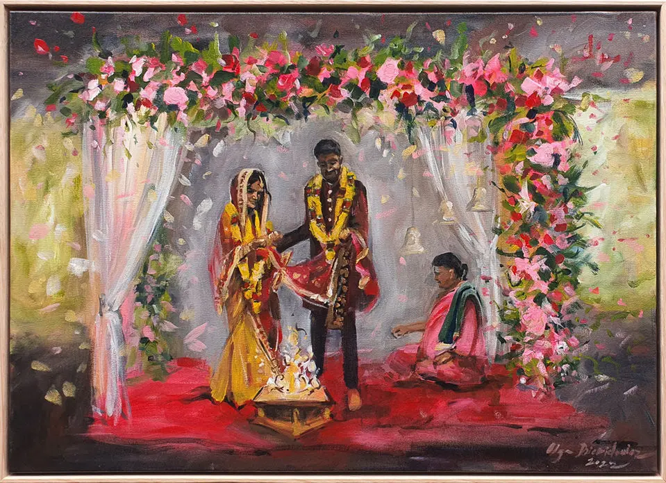 Couple exchanging vows under a vibrant floral archway